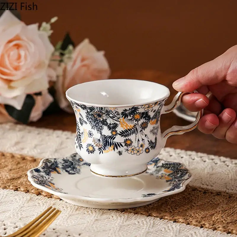 White porcelain classic tea cup set with navy blue and gold floral patterns and scalloped edges for dining room use