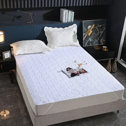 White quilted bed protector pad with diamond star pattern designed as a waterproof bed protector for bedroom use
