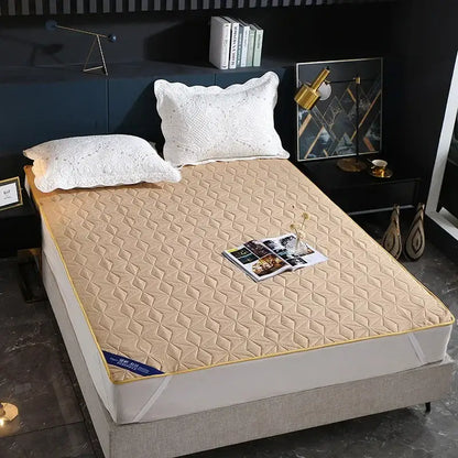 Beige quilted bed protector pad with yellow border and diamond pattern stitching for bedroom use