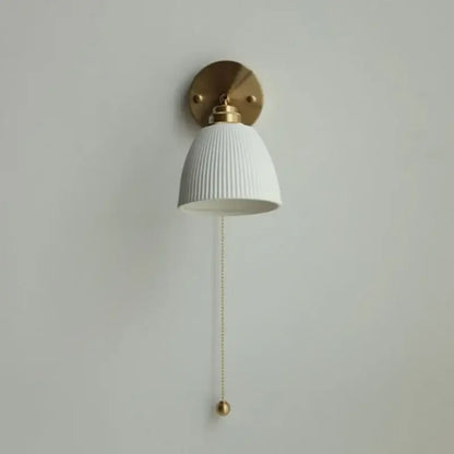 White ribbed ceramic led wall sconce with brass hardware and pull chain for bedroom by decorbites ceramic led