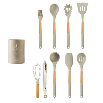 Set of ten white silicone kitchen cookware utensils with wooden handles and matching cylindrical storage container