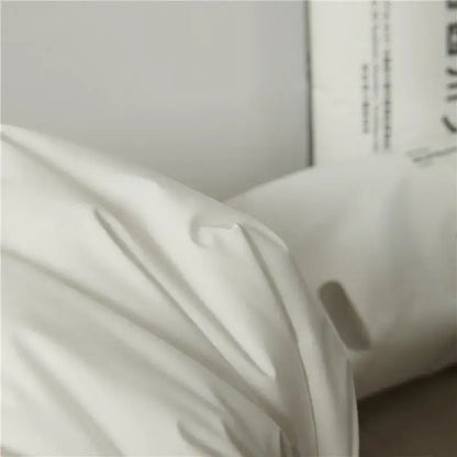 White textured cotton rectangle neck pillow with soft draped folds for bedroom bedding and neck support