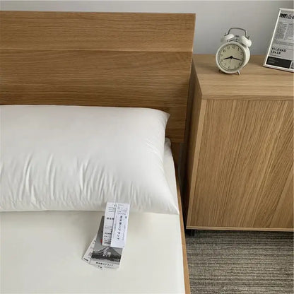 White textured cotton rectangle neck pillow with soft plush texture resting on bed for bedroom bedding