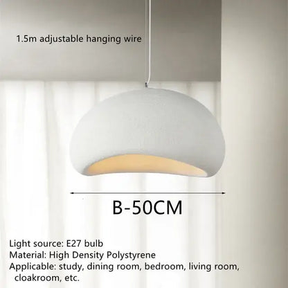 White dome-shaped handmade wabi sabi pendant lamp with textured polystyrene surface and warm interior glow for dining room decorbites