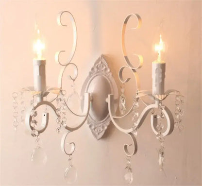 White wrought iron wall lamp with ornate scrollwork and decorbites crystal deco droplets for crystal deco loft decor