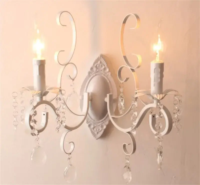 White wrought iron wall lamp with ornate scrollwork and decorbites crystal deco droplets for crystal deco loft decor