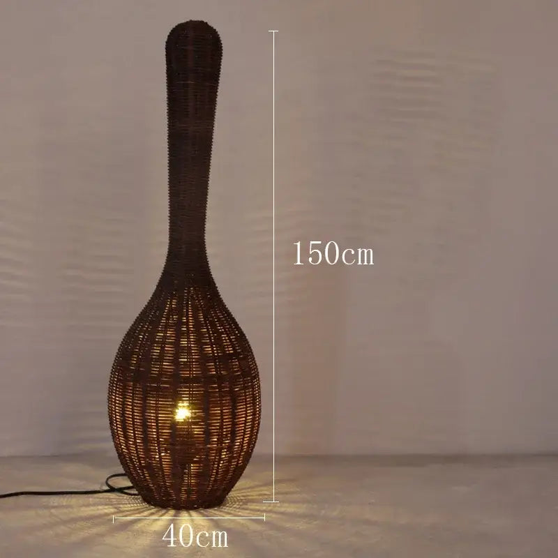 A tall dark brown woven rattan floor lamp with a slender neck and bulbous base for warm living room decorbites bamboo floor lamp