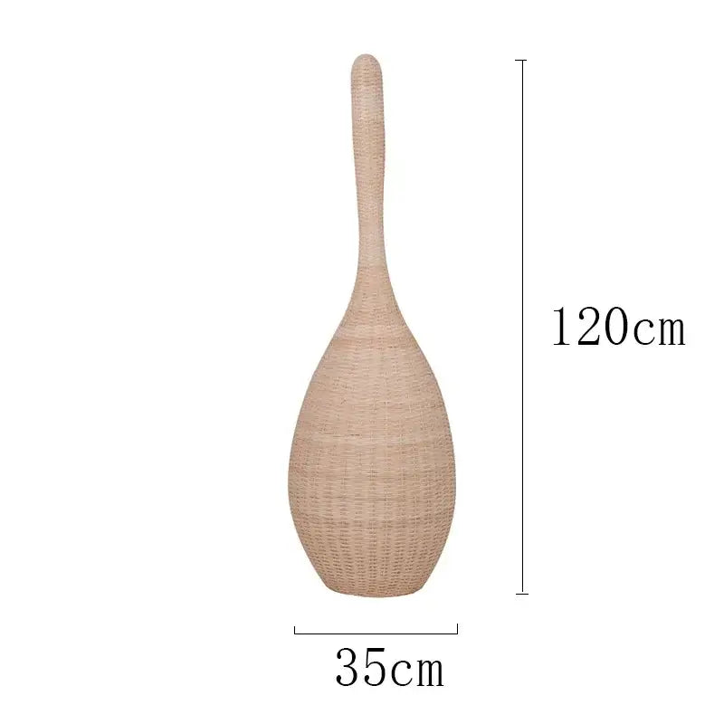 A tall beige woven rattan vase next to a dark brown bamboo floor lamp for warm living room decorbites bamboo floor decor