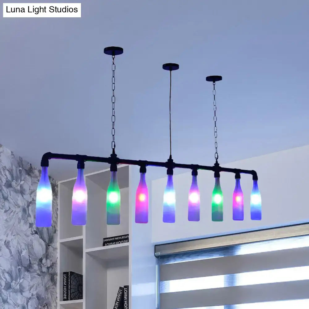A modern black metal decorbites island pendant light with seven colorful glass bottles and vibrant rainbow led lights