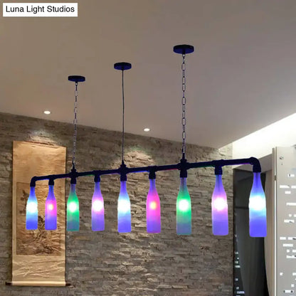 A DecorBites™ Art Deco island pendant light featuring seven colorful glass bottles with rainbow LED lights and black frame