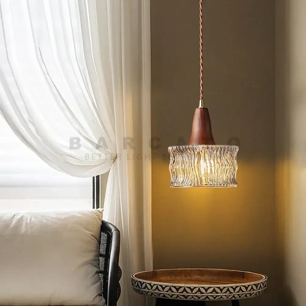 A warm-toned wood and textured glass pendant light with a wooden top and twisted copper cord compatible with led bulbs