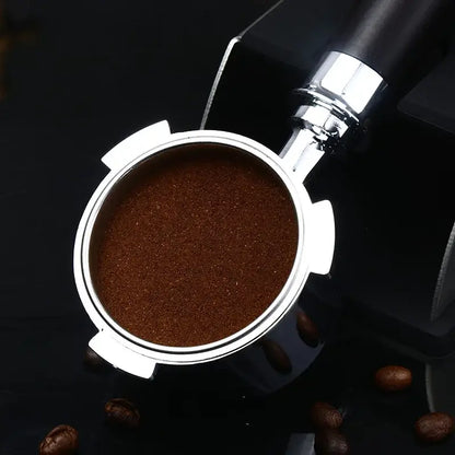 Silver espresso portafilter filled with finely ground coffee featuring wooden and black decorbites bottomless portafilter handle