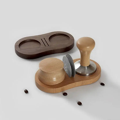 Light wood espresso distributor tamper and portafilter holder set with stainless steel puck screen on dark brown tray
