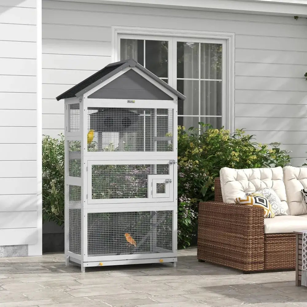White and gray metal outdoor bird aviary with wire mesh sides and a small door designed for finches and parakeets