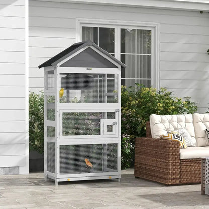 White and gray metal outdoor bird aviary with wire mesh sides and a small door designed for finches and parakeets