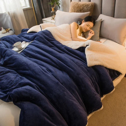 Deep navy wool throw blanket with soft cream fleece lining draped over a bed double sided queen size for winter warmth