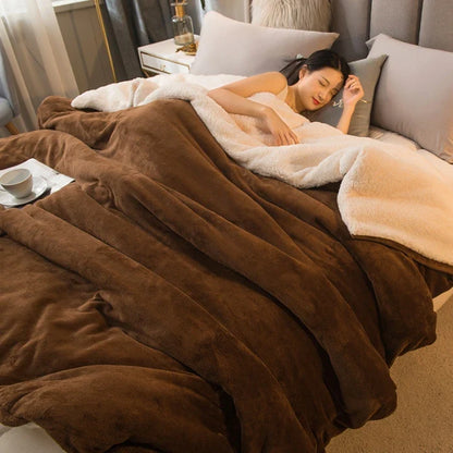 A plush two-toned brown and cream fleece wool throw blanket with soft texture ideal for winter bed or camping use