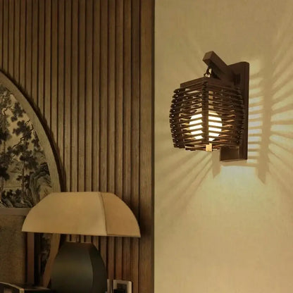 Dark wooden bamboo wall sconce light with woven lattice design casting warm light for corridor and cafe use