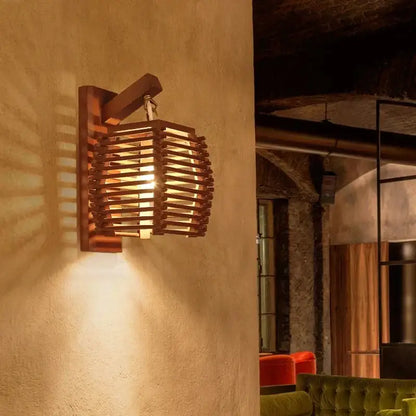 Warm-toned bamboo wall sconce light with woven slat design ideal for corridor and cafe lighting
