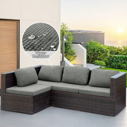 Dark brown woven wicker l-shaped modular sofa with gray cushions featuring brown and cream outdoor protection cover