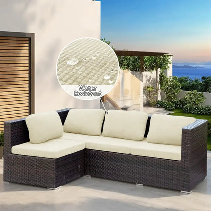 Dark brown woven wicker modular sofa with cream-colored cushions and brown and cream outdoor sectional cover protection