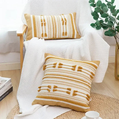 Two mustard-yellow and white woven geometric tassels cushion covers with tassel accents for living room decorbites decor