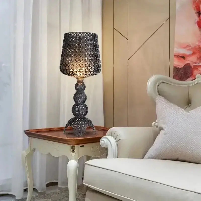 Dark intricately woven metal floor lamp with tiered base and ornate shade for decorbites acrylic kabuki table use