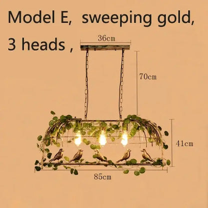 Sweeping gold wrought iron birdcage pendant lights with three heads, rustic metal frame, green ivy, and perched birds