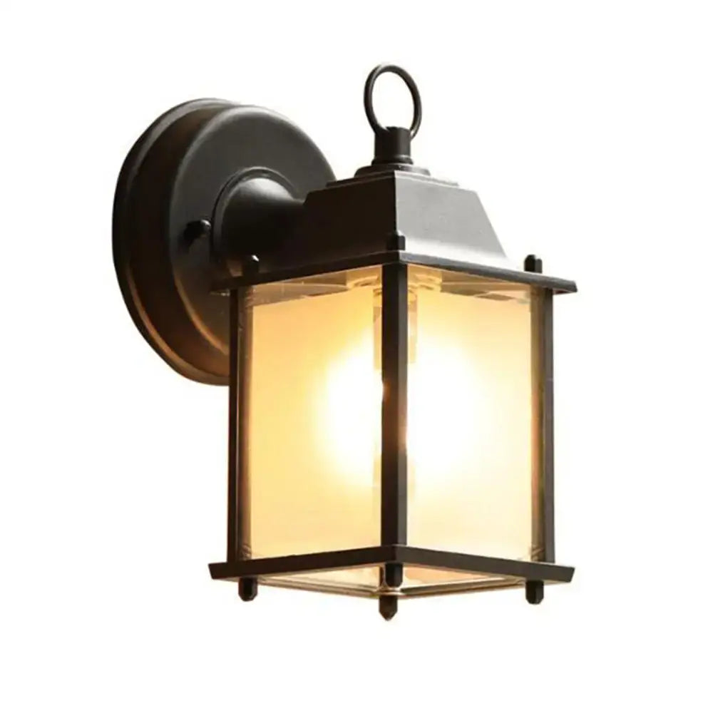 Black finish wrought iron wall lantern with clear glass panels and warm glowing light for outdoor porch decorbites black finish