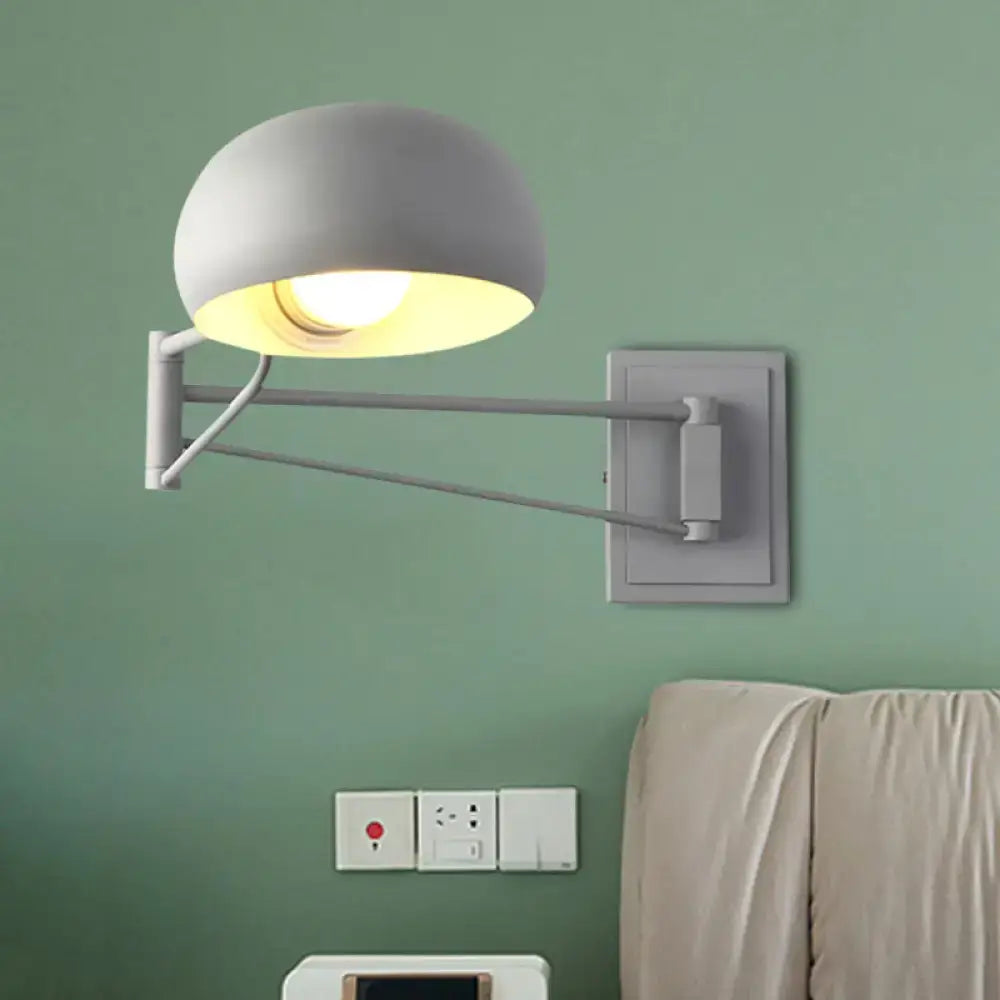 Modern gray wall-mounted lamp with sleek adjustable arm and bowl shade suitable for bedroom lighting