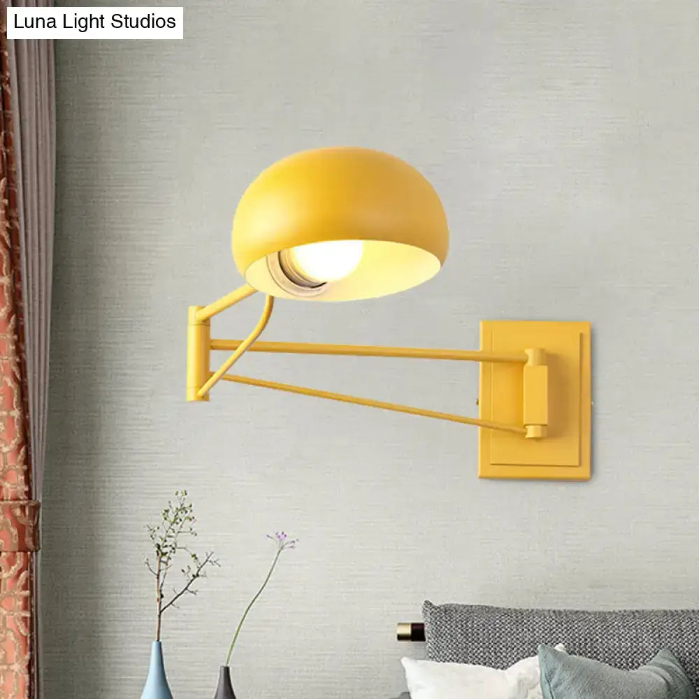 Bright yellow adjustable metal wall sconce with bowl shade and articulated arm for bedroom lighting