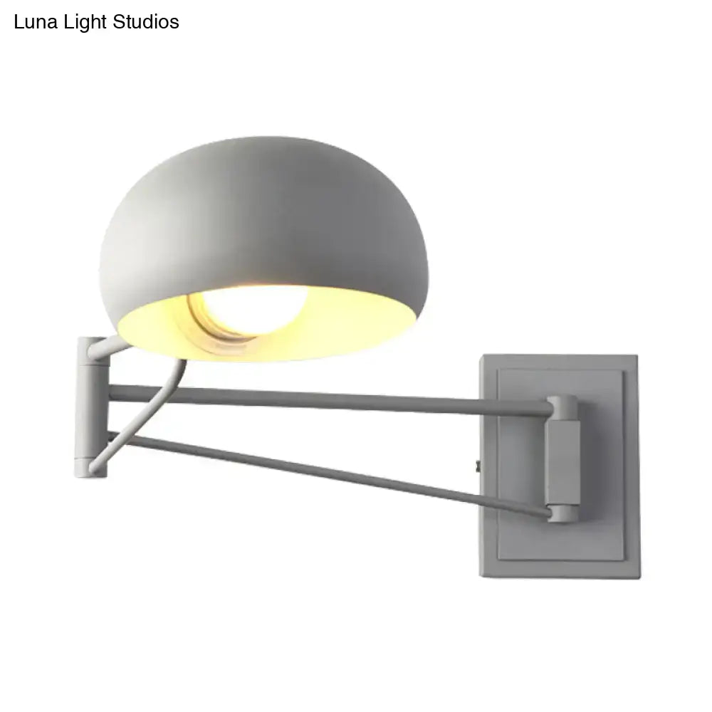 Gray dome-shaped wall sconce with bowl shade and adjustable articulated arm in matte metal for bedroom use