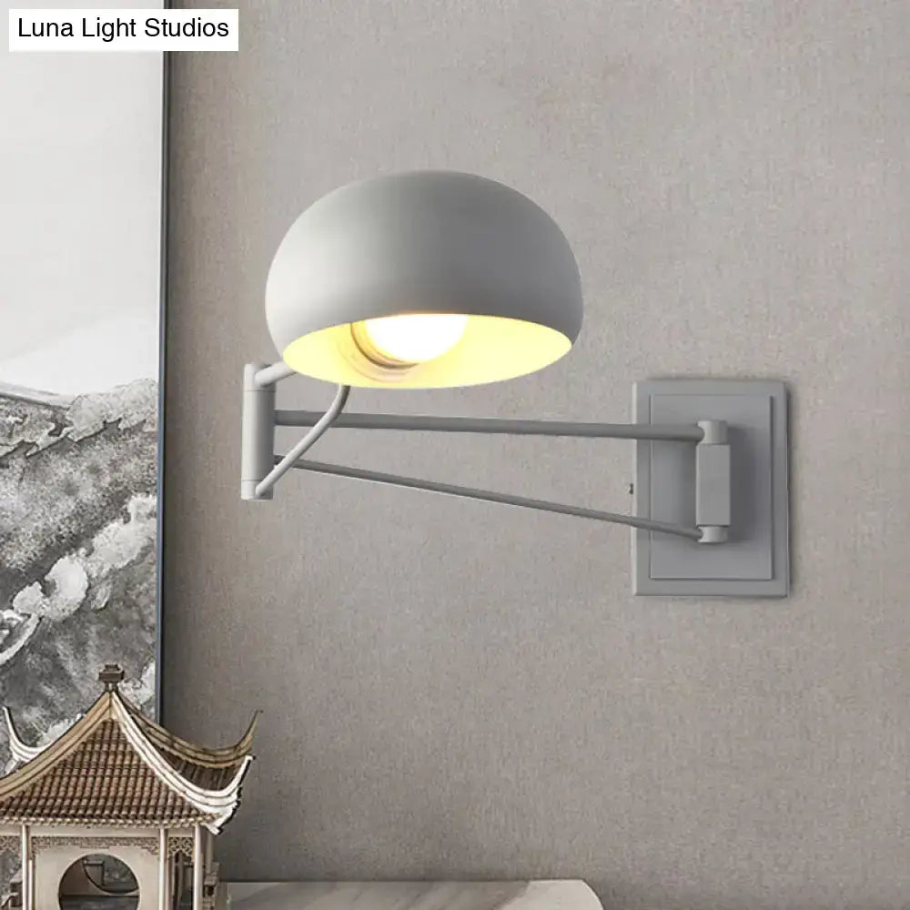 Gray adjustable metal wall sconce with bowl shade and articulated arm for versatile bedroom lighting