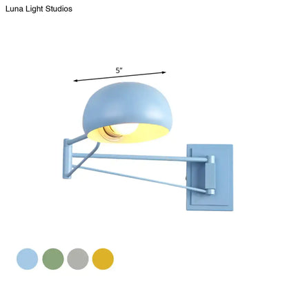 Light blue adjustable metal wall-mounted reading lamp with dome-shaped bowl shade and articulated arm for bedroom use