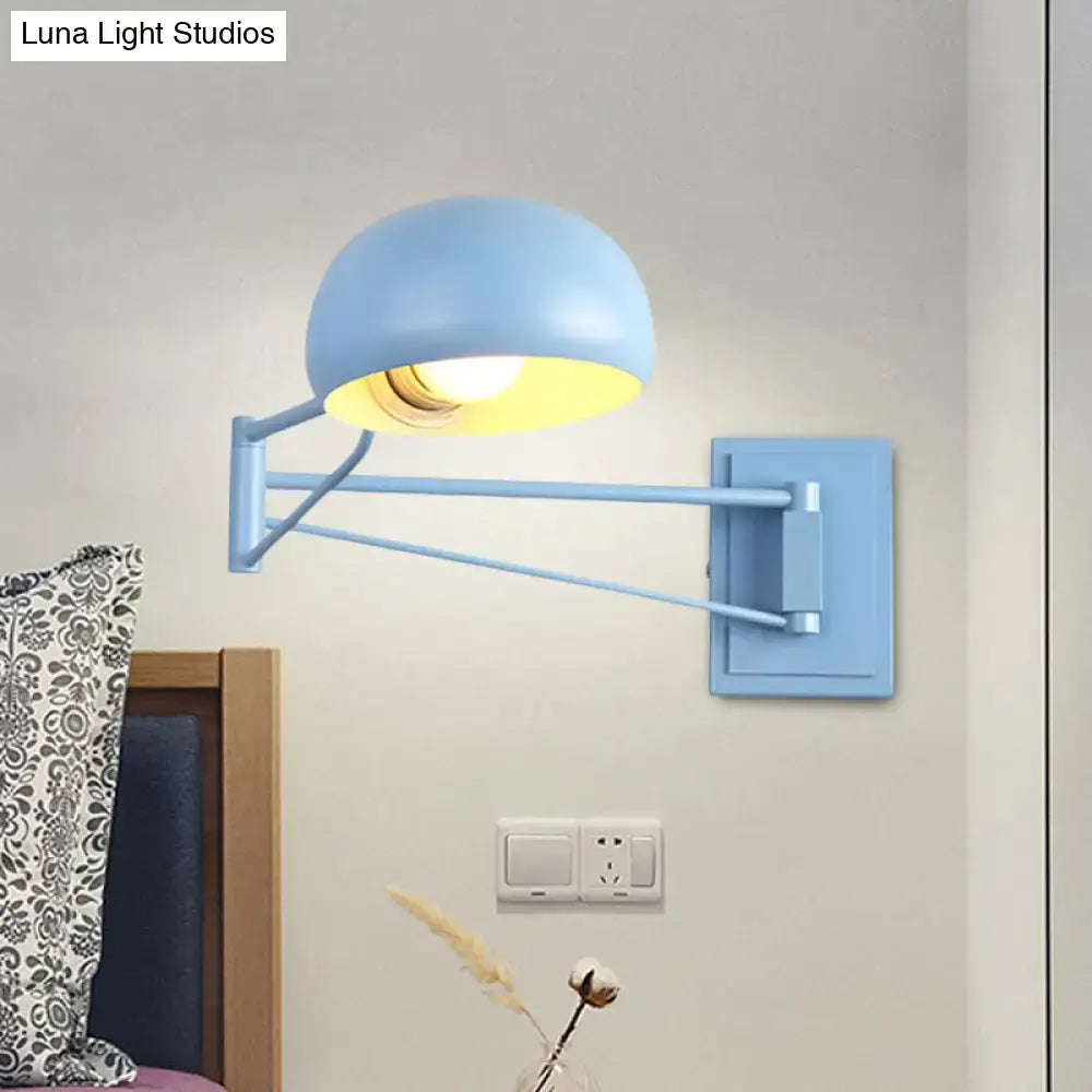Light blue adjustable metal wall sconce with dome bowl shade and articulated arm for bedroom lighting