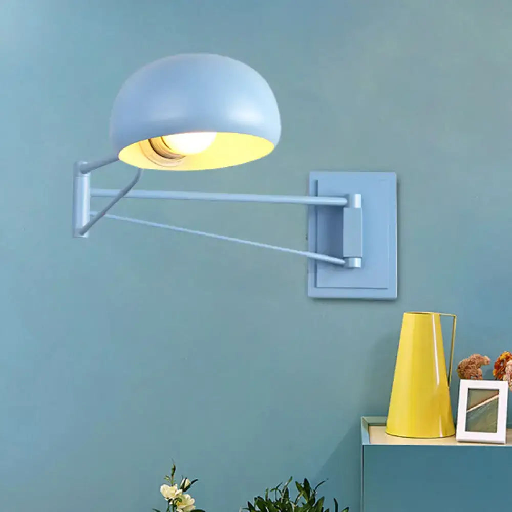 Light blue dome-shaped wall sconce with adjustable metallic arm and bowl shade for bedroom lighting