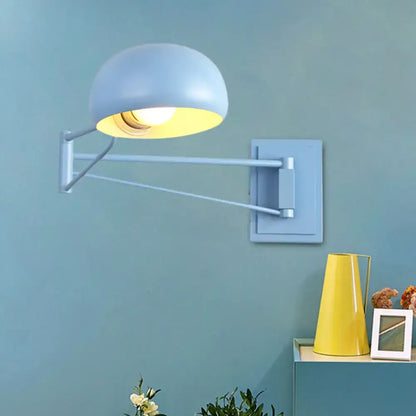Light blue dome-shaped wall sconce with adjustable metallic arm and bowl shade for bedroom lighting