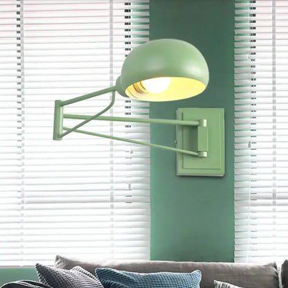 Yellow adjustable metal wall sconce with matte sage green finish and bowl shade for bedroom reading, wall-mounted design