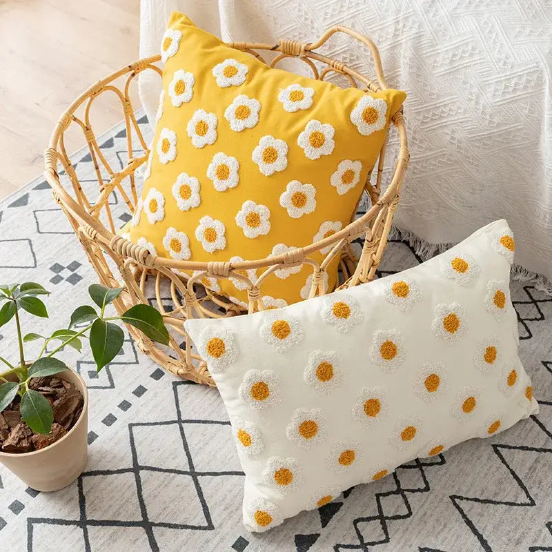 Yellow pillow cover with white and yellow decorbites daisy floral embroidery in a woven basket for living room decor