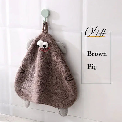 Brown plush pig-shaped hand towel with embroidered eyes and stitched details from decorbites cartoon animal hand collection