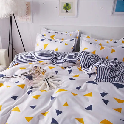 White duvet cover and pillowcases with a yellow and navy blue triangle pattern in decorbites cartoon printed bedding set