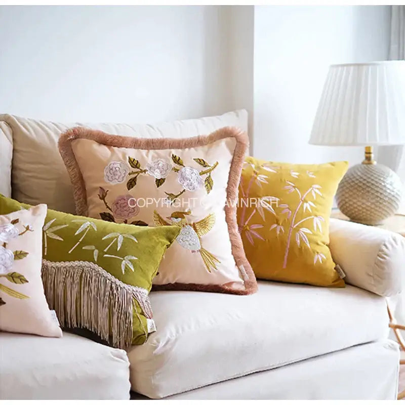 Beige throw pillow cover with embroidered floral and bird design, fringed border in peach yellow bamboo velvet fabric