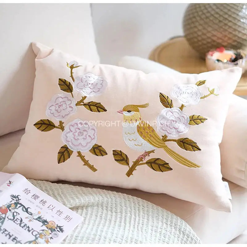 Yellow bamboo velvet throw pillow cover in blush pink with intricate white floral embroidery and golden bird design