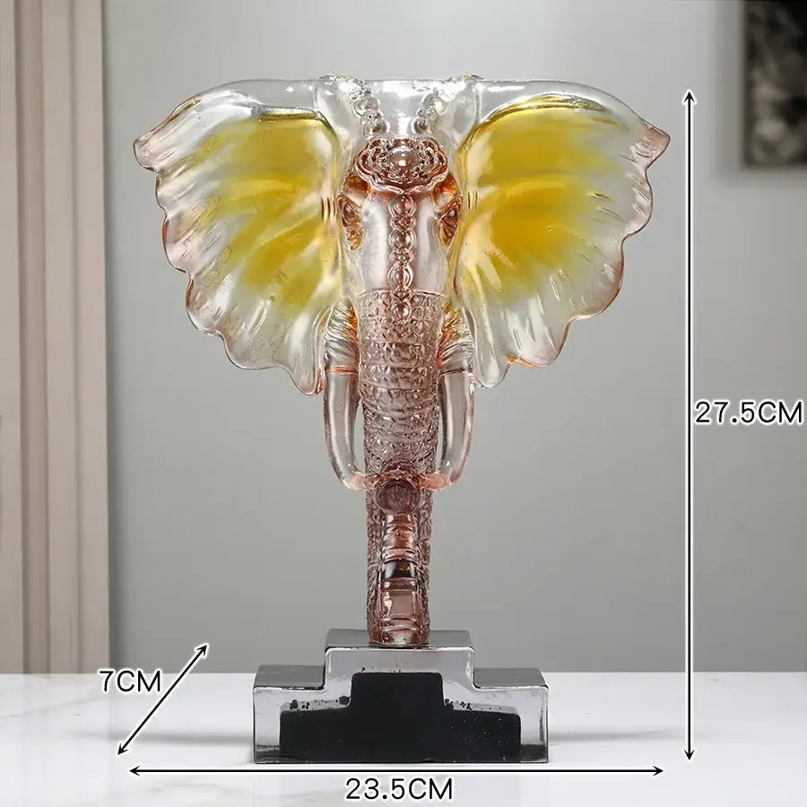 Yellow and blue crystal elephant sculpture with golden yellow ears and rose gold details on clear base for home decor