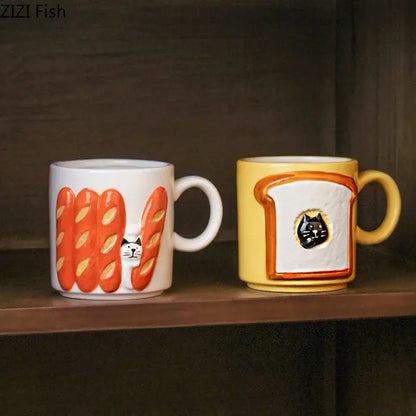 Two ceramic mugs featuring bread pattern ceramic designs with a white peeking cat and yellow toast cup illustration