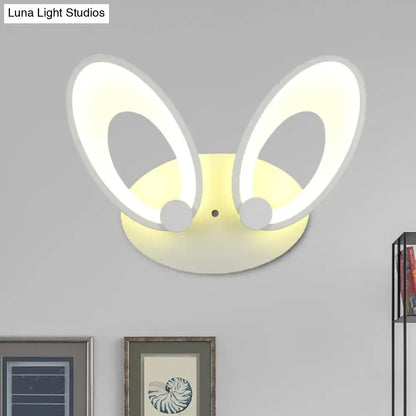 A modern yellow bunny led ceiling light with white finish glowing oval ears for bedroom decor