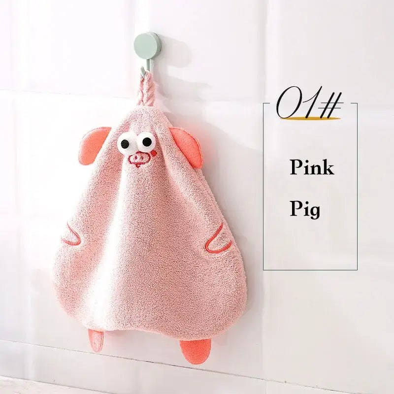 Pink cartoon pig plush hand towel with embroidered eyes snout soft fabric and orange accents by decorbites cartoon pig