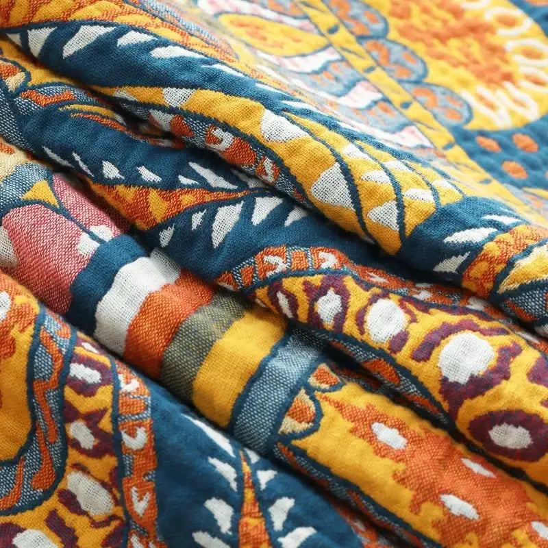 A vibrant yellow cotton mandala leisure blanket with bold orange and deep blue paisley patterns for living room decorbites cotton mandala