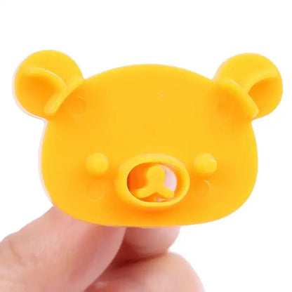 Bright yellow silicone bear sandwich mold and cookie cutter baking set with rounded ears and smiling face