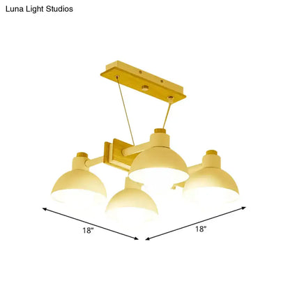 Yellow metal dome shade linear chandelier with three dome-shaped light fixtures and adjustable chain cord length